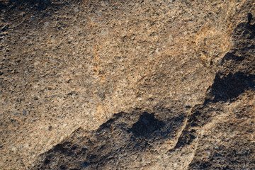 Background of natural stone. A snapshot of granite boulder (Latin 