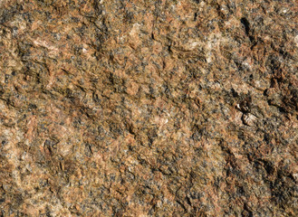 Background of natural stone. A snapshot of granite boulder (Latin 