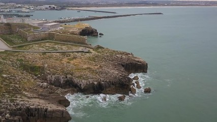 Aerial footage of a beautiful view of the port and the fort from above in Peniche, Portugal. 4k quality in motion.