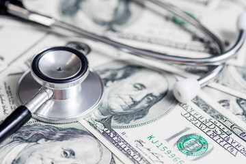 Stethoscope on the dollars. Medical costs. Healthcare payment concept. Concept of analysis of the...