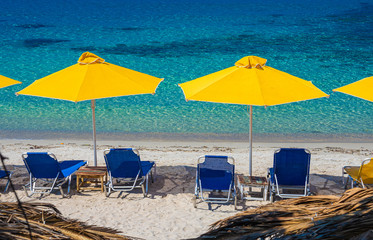 Landscape with sun umbrella and lounge chair on Aliki beach at Thassos islands, Greece