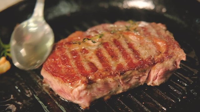 Seasoned red meat sirloin cooking. Pork chop recipe. Chef juicing red meat steak on frying pan.