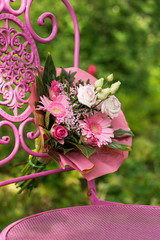 Pink flower bouquet on a garden chair