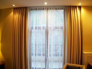 Curtains and tulle in the interior of the apartment