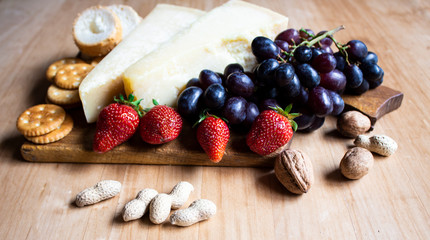 Cheese, grapes and klujunika on the background