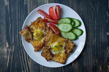 Grilled sandwich with egg, vegetables and bacon on a dark wooden background. Tasty breakfast.