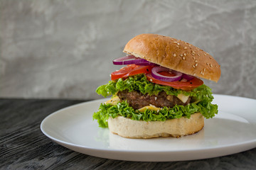 Fresh homemade burger on a white plate. Unhealthy food.