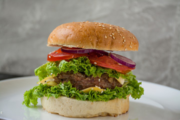Fresh homemade burger on a white plate. Unhealthy food.
