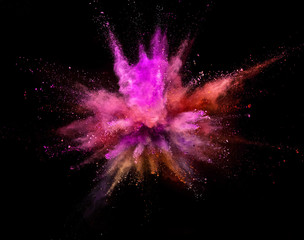 Colored powder explosion on black background. Freeze motion.