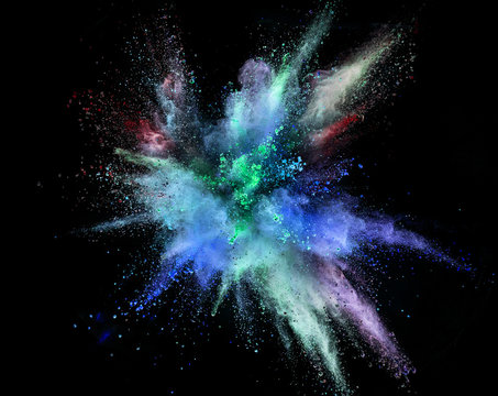 Colored powder explosion on black background. Freeze motion.