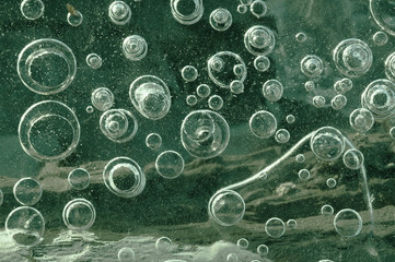 Texture abstract closeup background ice with bubbles of air caught by frost in the mass of water while freezing