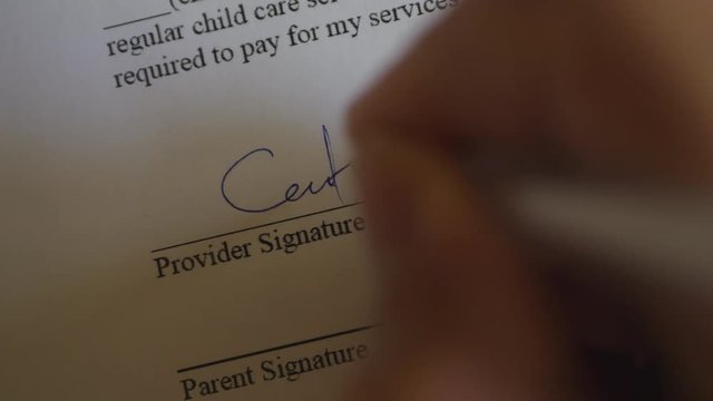 The Man Signs The Document With His Signature. Slider Shot. Fake signature. Fake Document.