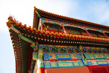 Obraz premium Impressive colorful elaborate roof from the forbidden city in Beijing, China. The colors of the roofs, roofing materials and roofing are filled with symbols.