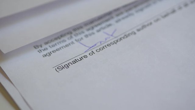 The Man Signs The Document With His Signature With Glasses. Fake signature. Fake Document