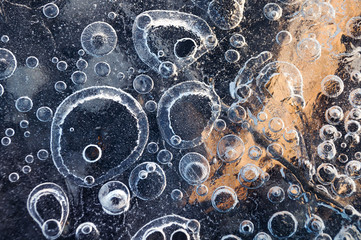 Texture abstract closeup background ice with bubbles of air caught by frost in the mass of water while freezing