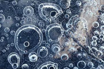 Texture abstract closeup background ice with bubbles of air caught by frost in the mass of water while freezing