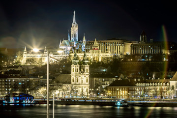 Obraz premium Night view of St. Matthias Church from the east side of Danube with motor ships on it