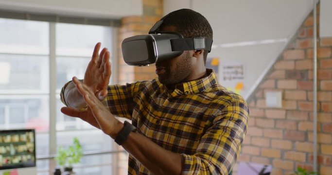 Male graphic designer using virtual reality headset in office 4k