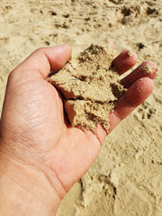 Sand in the man's hand