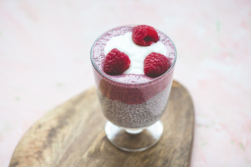 Chia pudding with almond milk, yogurt, pitaya powder and raspberries. Vegan concept.