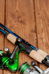 Fishing tackle - fishing spinning, hooks and lures on wooden background with copy space