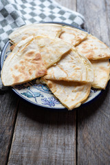 Mexican quesadillas cutted in triangle with flour tortillas and red sauce