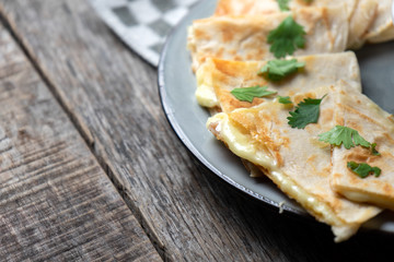 Mexican quesadillas cutted in triangle with flour tortillas and red sauce