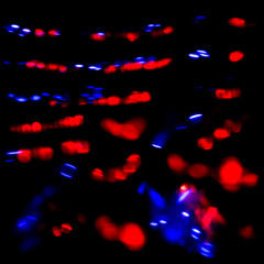 Naklejka na ściany i meble texture bokeh blue and red from the flashing lights of police cars and ambulances. Optical effects from flashing lights of special machines