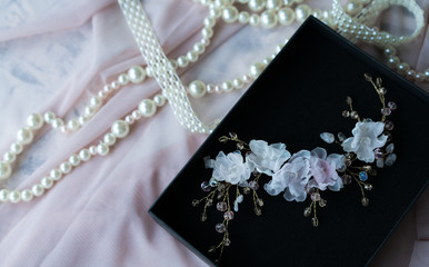 Wedding background with pearls and hair accessories on pink background