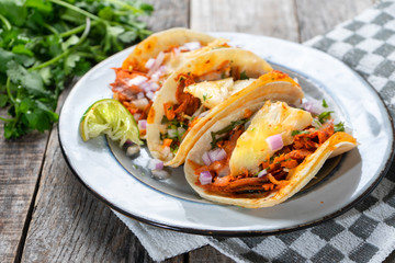 Mexican food: Authentic tacos al pastor with lime and pineapple