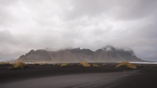 Timelapse of famous Stokksnes mountains with clouds moving in view