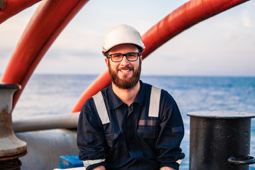 Deck Officer on deck of offshore vessel or ship , wearing PPE personal protective equipment