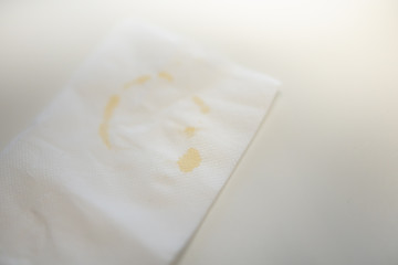 Close up of white napkin tissue paper with circle mark and spot of coffee dirty.