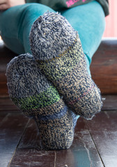 Legs in knitted socks as a symbol of country life