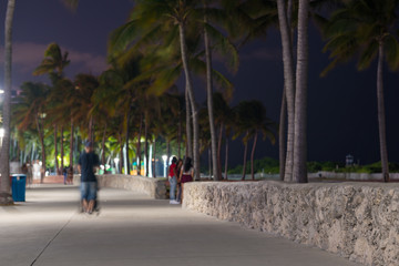 People on Ocean Drive pedestrian walkway Lummus Park at night