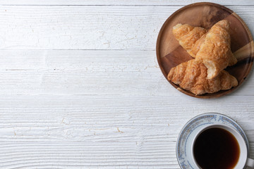 Whole wheat croissant and cup of coffee