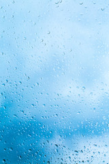 Drops of rain on blue glass background