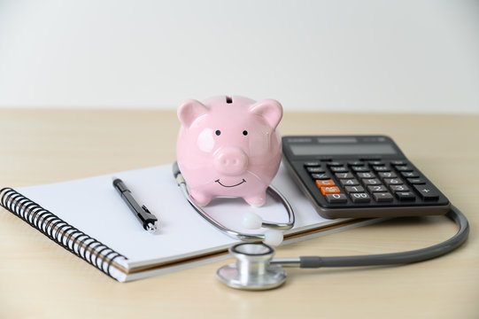 Piggy Bank With Stethoscope  Financial Checkup Or Saving For Medical Insurance Costs