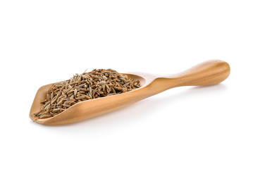 caraway seeds in wood scoop on white background