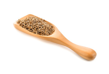 caraway seeds in wood scoop on white background