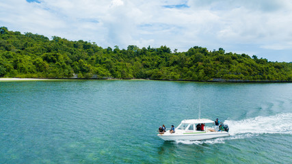 Fototapeta na wymiar Aerial photography view of Wakatobi (Wangi-Wangi, Kaledupa, Tomia & Binongko) islands with a white boat, Southeast Sulawesi, Indonesia