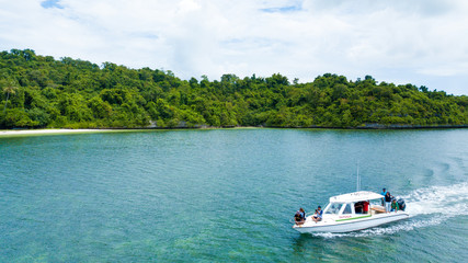 Naklejka na ściany i meble Aerial photography view of Wakatobi (Wangi-Wangi, Kaledupa, Tomia & Binongko) islands with a white boat, Southeast Sulawesi, Indonesia