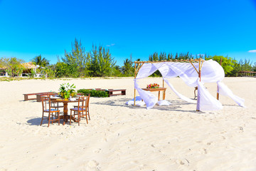 beach chairs and umbrella on the beach, wedding beach, chinese new year, new year, banquet, year-end party, new year party, table setting, beach party, wedding tent and cake table