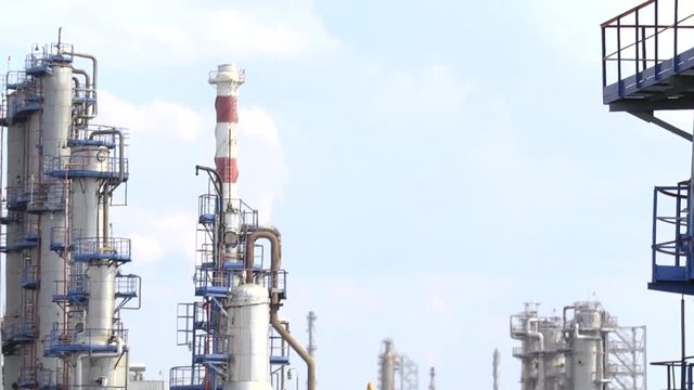 Oil refinery industry. View from the platform to the factory. Refined chimney pipe of a petrochemical oil plant. catalyst, factory. Industrial zone, The equipment of oil refining.