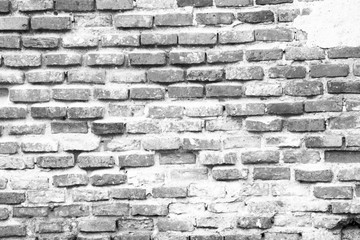 The old brick wall shows the arrangement of the aged bricks in black and white tones.