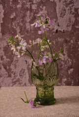 Small spring flower bouquet in emerald glass