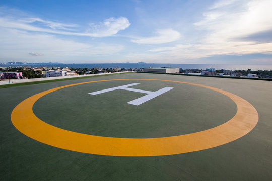 Symbols for helicopter parking on the roof of an office building. Empty square front of city skyline. Offshore helicopter parking pad on an offshore installation platform.