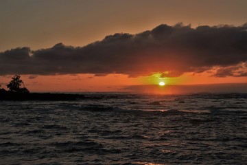Naklejka na ściany i meble Dusk and sun setting over a beautiful ocean
