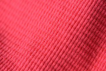 Textile texture coral color close up. Textile background