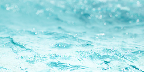 Blurred water, glittering bokeh abstract; background nature